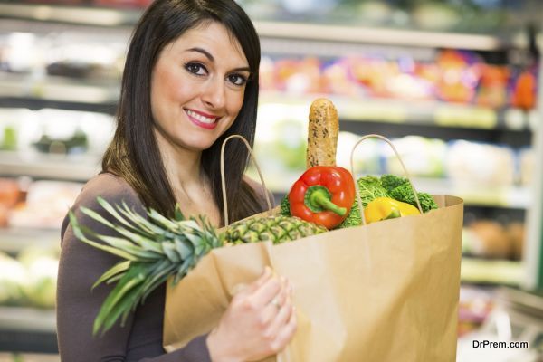 Smiling woman shopping in a supermarket