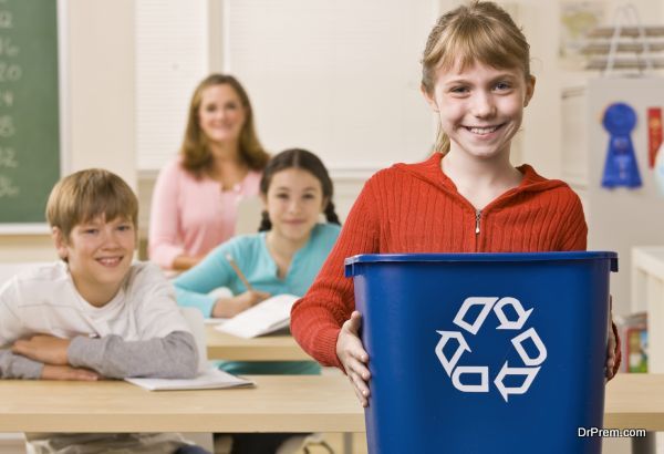 Student carrying recycling bin