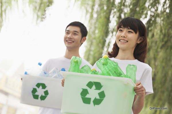 Two Young People Recycling Plastic Bottles