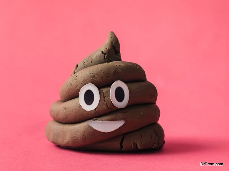 Poop emoticon on pink background.