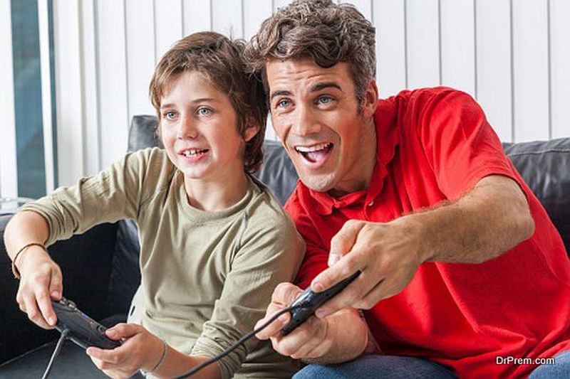 father and son playing video game