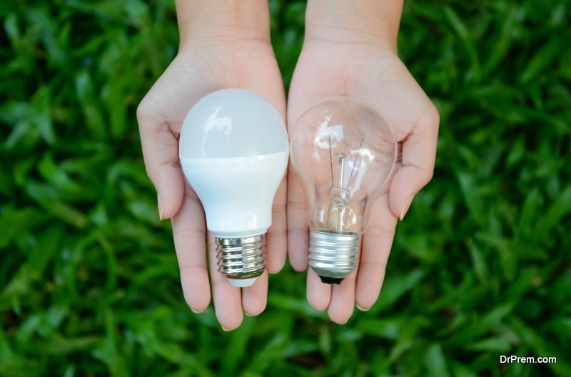 LED and Fluorescent bulb comparing on woman hand for alternative technology concept