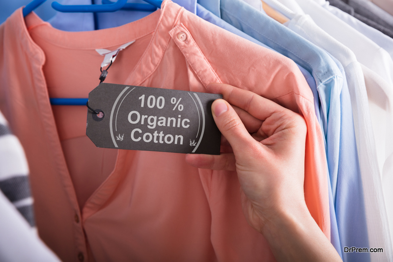 Woman's Hand Holding Label Showing 100 Percent Organic Cotton