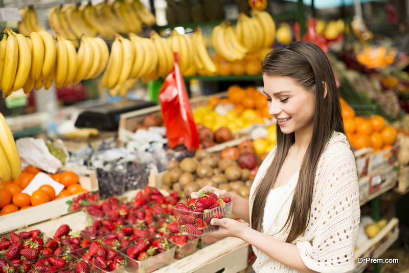 woman buying fruits from local market