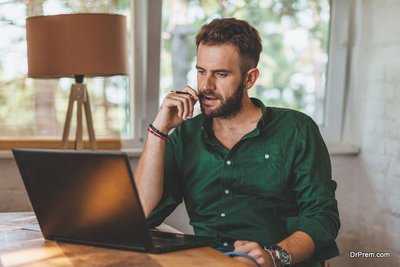 Young man having sressful time working on laptop